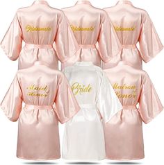 six bridesmaid robes in pink and white with gold lettering on the front, one is