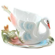 a white swan cup and saucer on a plate