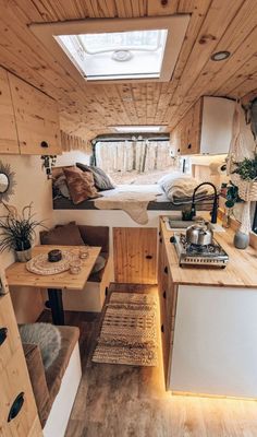 the interior of a tiny home with wood paneling and white walls, including a bed