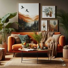 a living room with orange couches and pictures on the wall above them, along with potted plants