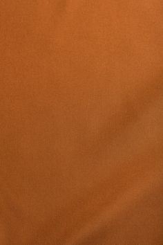 an orange colored fabric with very thin lines on the bottom and sides, as well as some small white dots