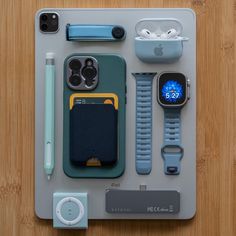 an apple watch, cell phone, and other accessories laid out on a table top