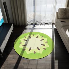 a living room with a couch, television and large glass door leading to the balcony