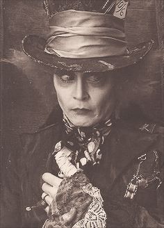 an old photo of a woman wearing a hat and holding something in her right hand