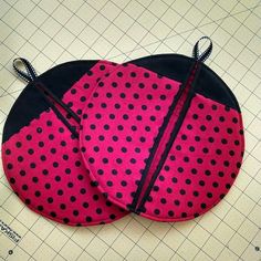 two pink and black polka dot covered plates on a cutting board with scissors in the middle