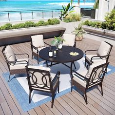 a table and chairs sitting on top of a wooden deck