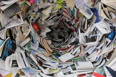 a pile of books that have been piled on top of each other with phones in the middle