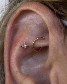 an ear piercing with a star and moon on it