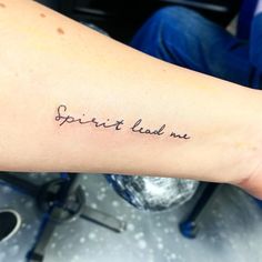 a woman's arm with the words spirit lead me tattooed in cursive font