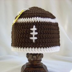 a crocheted football hat on top of a lamp