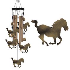 a wind chime with horses and bells hanging from it's sides, on a white background