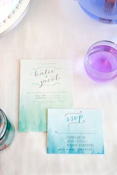 the wedding stationery is laid out on the table