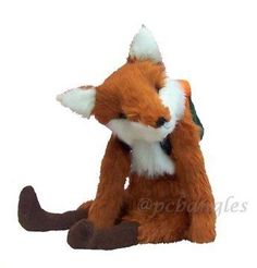 a small stuffed fox sitting on the ground