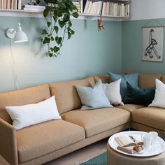 a living room filled with furniture and lots of books on the shelf next to it