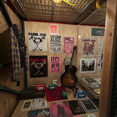 a room filled with lots of posters and guitars