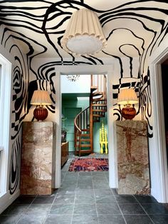 an entry way with zebra print on the wall and stairs leading up to another room