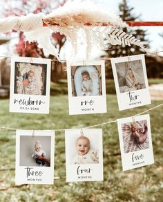 some pictures hanging from a clothes line with baby's names on them and feathers