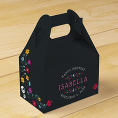 a small black bag with flowers on it