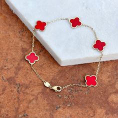 14KT yellow gold red enamel 4-leaf clover station charms thin chain bracelet. Great, minimal gold bracelet for layering! More colors may be available. Length: 7" Chain width: 1mm diamond-cut cable chain 10mm wide flat clover charms (5) total clovers Weight: 2.0 grams 14K lobster clasp Stamped 14K Solid gold Minimal Gold Bracelet, Saint Jewelry, Minimal Gold, Gold Armband, Clover Charm, Clover Leaf, Chain Link Bracelet, Cable Chain, Red Gold