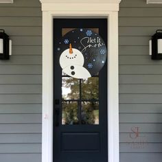 a black door with a snowman sign on it