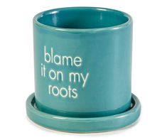 a teal mug with the words,'blame it on my roots '