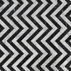 black and white marble chevroned tile with an interesting pattern in the center,