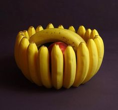 a bunch of bananas sitting on top of each other with an apple in the middle