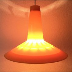 an orange light hanging from a ceiling in a room