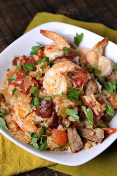 a white plate topped with rice and shrimp