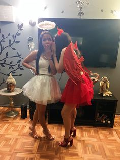 two women dressed in red and white posing for the camera with their hands on their mouths