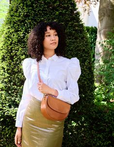 Inspired by our original Meghan bag from 2018, Ava is a modern and refined crossbody bag. The curved silhouette and firm structure make it the perfect saddle bag for street-style lovers with a luxurious touch. The half-moon shape is reminiscent of 90’s New York street style and is just as practical as is beautiful. Finished with an inside zipper pocket and the magnetic closure flap, Ava makes a versatile choice for everyday wear. OMB-E163BV Luxury Cognac Saddle Bag, Classic Cognac Crossbody Bag, Elegant Cognac Shoulder Bag For On-the-go, Cognac Crossbody Bucket Bag For On-the-go, Cognac Leather-lined Crossbody Bag, Crossbody Saddle Bag, New York Street Style, Sustainable Leather, Moon Shape