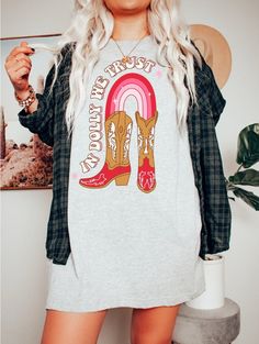 "🌟 Introducing \"In Dolly We Trust\" Vintage Western T-Shirt! 🌟 🤠 Calling all cowgirls, cowboys, and fans of the legendary country superstar, Dolly Parton! Get ready to make a bold statement with our breathtaking \"In Dolly We Trust\" Vintage Western T-Shirt. This isn't just any ordinary shirt--it's a work of art that will transform your wardrobe and elevate your style to new heights. ✨ Unleash Your Inner Western Charm: Step into the world of vintage vibes and Western country music with our u Country Style T-shirt For Rodeo In Fall, Retro Fall Rodeo T-shirt, Fall Graphic Print T-shirt For Country Events, Vintage Tops For Fall Country Concerts, Cowgirl T Shirt, Ladies Western Shirts, In Dolly We Trust, Bridal Shower Shirts, Couples Clothes