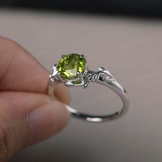 This is a gorgeous handmade creation, a combination of beauty, simplicity & Elegance. The 7*7mm round cut peridot is crafted in solid sterling silver and with rhodium plated. 14K white gold/rose gold/yellow gold available as well,pls contact me if you need. All item is sent in a beautiful gift box You can realize more lovely stuff clicking the link https://www.etsy.com/shop/knightjewelry?refshopsection_shophome_leftnav Please leave the correct address and you phone number for delivering succ August Birthstone Ring, Leaves Ring, Green Sapphire Ring, August Birthstone, Peridot Ring, Leaf Ring, August Birth Stone, Garnet Rings, Delicate Rings