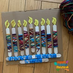 the craft is made with pops sticks and yarn