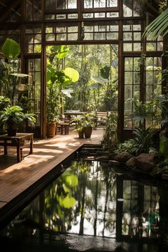 an indoor pool surrounded by plants and trees