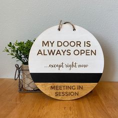 a sign that says, my door is always open except right now meeting in session