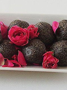 chocolate truffles with pink flowers in a white bowl