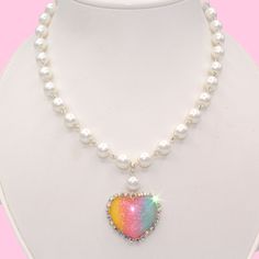 Only 2 left! See 2nd image to select which pendant you want. Details: Features a pastel rainbow gradient resin heart pendant with silver glitter embedded (*note that every heart is slightly different) Pendant is surrounded by iridescent crystal rhinestones High quality heavy glass pearl chain Adjustable length Silver plated components Handmade Measurements: Necklace is adjustable from 18-21" Pendant is a little over 1" in size *Only a few left! See 2nd photo to see the remaining hearts that your Cheap Trendy Pastel Jewelry, Trendy Cheap Pastel Jewelry, Cheap Casual Pastel Jewelry, Danish Pastel Necklace, Affordable Handmade Pastel Jewelry, Trinket Necklace, Pastel Rainbow Gradient, Caribbean Art, Rainbow Gradient