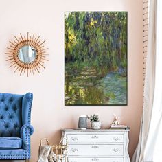 a living room with a blue chair and a painting on the wall next to a dresser