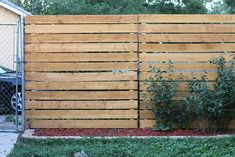 a wooden fence in front of a house