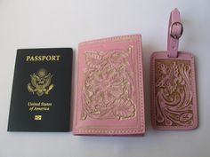 two passport cases, one pink and the other gold