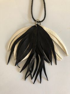 A beautifully white and black colored lambskin leaf leather necklace. Gorgeously comfortable and easy to wear. string is made from leather. Color might be altered due to the lighting of the photo taken. Handmade Black Leather Necklace, Handmade White Leather Jewelry, Chic White Handmade Necklace, Polymer Crafts, Wedding Jewellery Necklace, Leather Necklace, Special Design, Leather Jewelry, Wedding Necklace