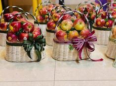 baskets filled with apples sitting on top of a table