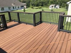 a wooden deck with black rails and railings