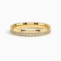 a yellow gold wedding band with diamonds