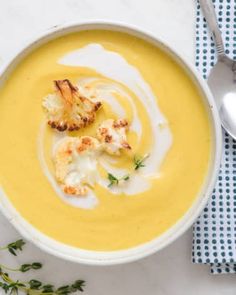 a white bowl filled with soup and garnished with croutons