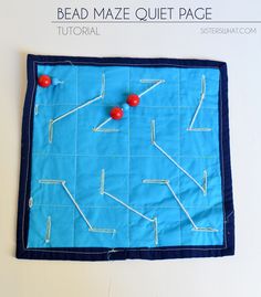 the bead maze quiet page is made with blue material and red balls on it