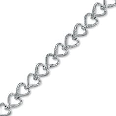 This charming bracelet is perfect for the passionate woman who wears her heart on her sleeve. This sweet style showcases a lovely chain of linked hearts tenderly crafted in fine sterling silver. Understated accent diamonds are lightly sprinkled on one side of each heart. This delightful 1/15 ct. t.w. diamond accessory measures 7.0 inches in length and secures with a lobster claw clasp. Elegant Silver Diamond Bracelet For Valentine's Day, White Gold Heart Diamond Bracelet For Valentine's Day, Heart-shaped White Gold Diamond Bracelet For Valentine's Day, Valentine's Day White Gold Heart Diamond Bracelet, Valentine's Day Heart-shaped White Gold Diamond Bracelet, Silver Heart-shaped Diamond Bracelet For Formal Occasions, Silver Diamond Bracelet For Wedding On Valentine's Day, Silver Diamond Bracelet For Valentine's Day Wedding, Silver Diamond Bracelet For Wedding And Valentine's Day