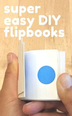 a hand holding an open book with the title super easy diy flipbooks