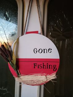 a sign that says gone fishing hanging on a door